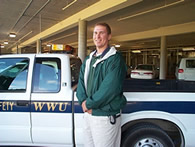 Public Safety Assistant standing next to WWU vehicle